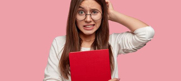 Stressed and uncertain teenage girl is having an oral exam