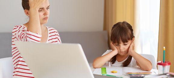 Tired and frustrated mother and child trying to do homework