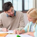Private tutor helping girl with homework