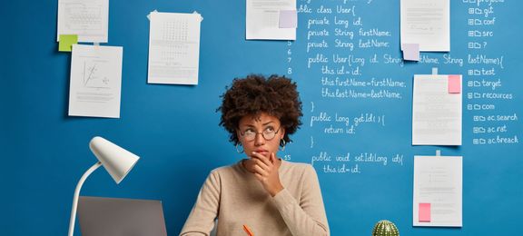 Thinking woman planning in her notebooks