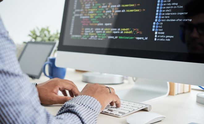 Man coding on his computer