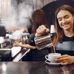 Young barista making coffee